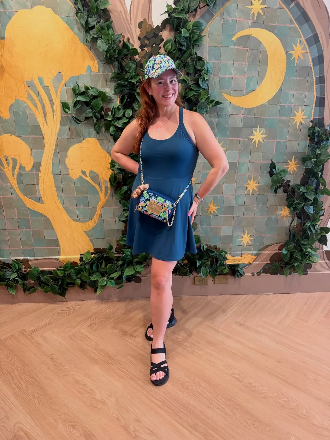 Victoria smiling in front of a Disney-inspired mural