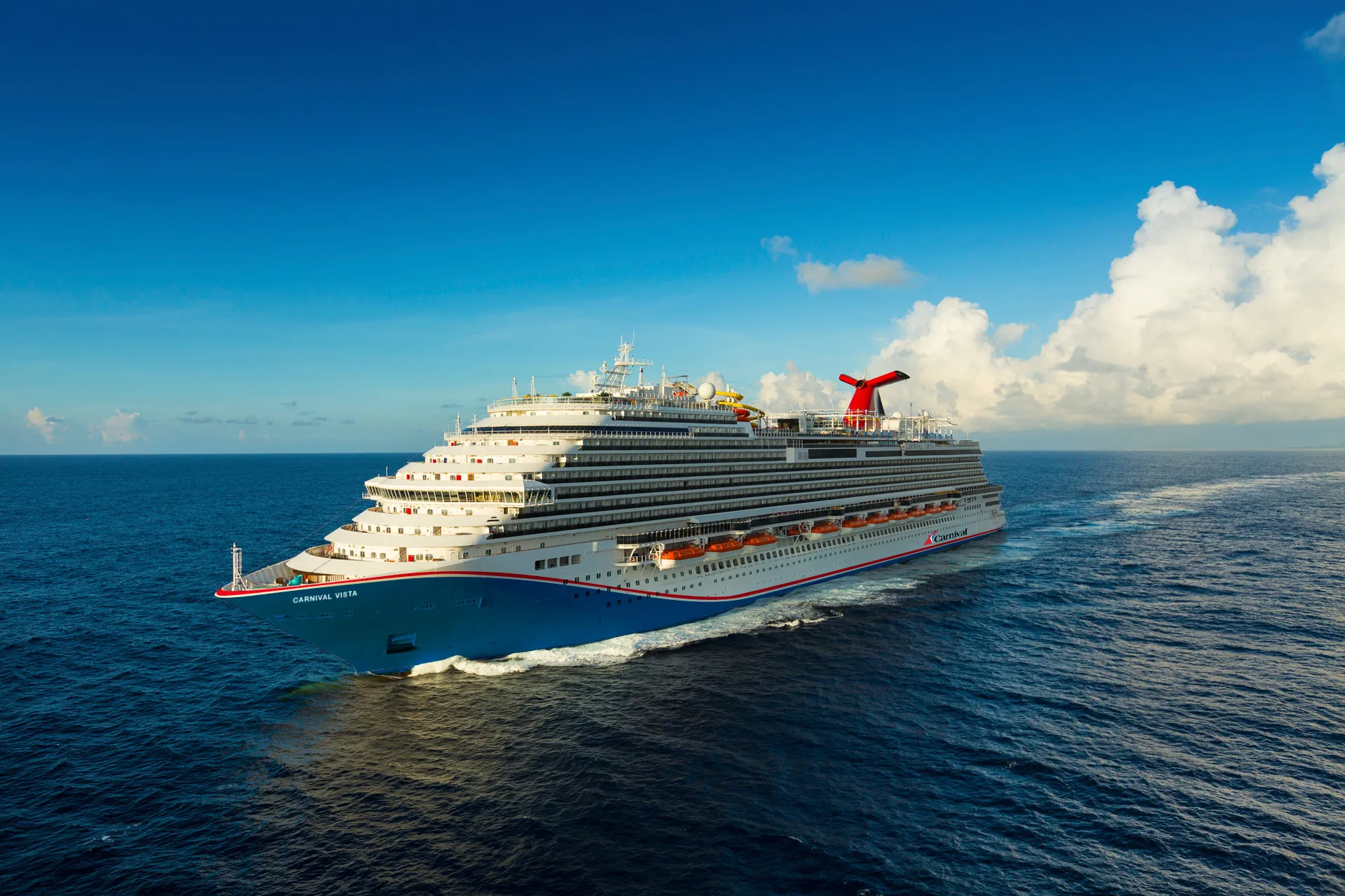 Carnival Vista at sea with her red, white and blue hull